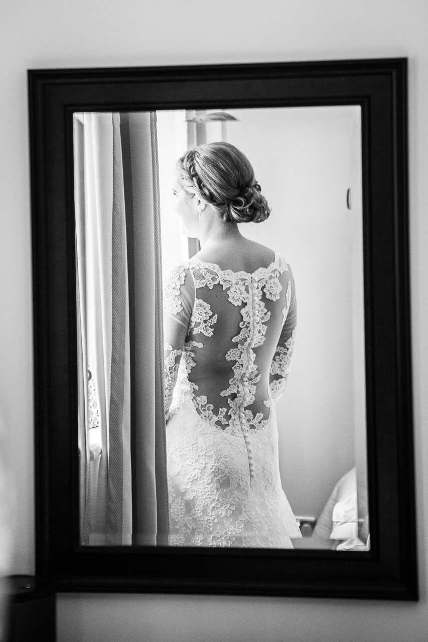 bride looking out of window with back to camera