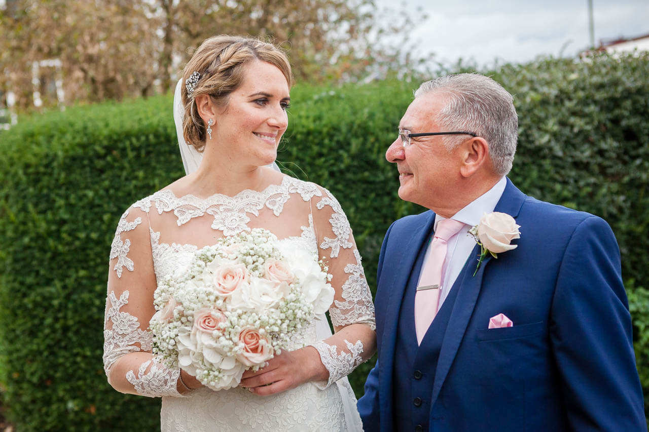 bride and father look to each other