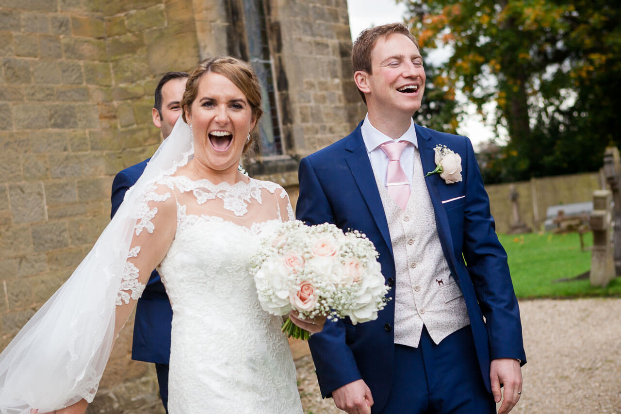 bride and groom laughing wildly
