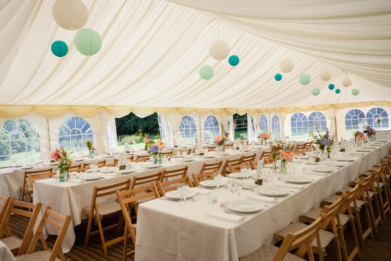 inside of marquee decorations with tables and chairs. Mint green theme