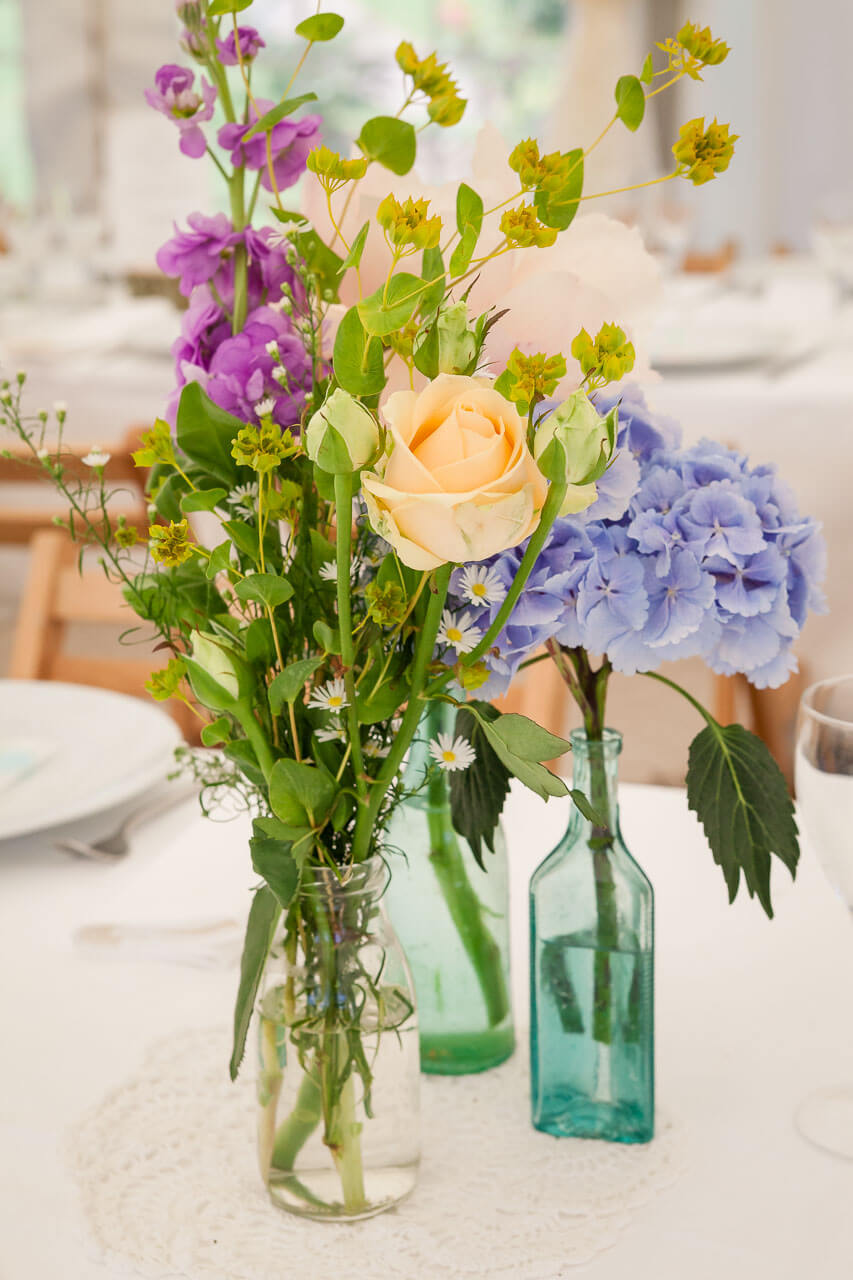 table flowers, peach, purple and blues
