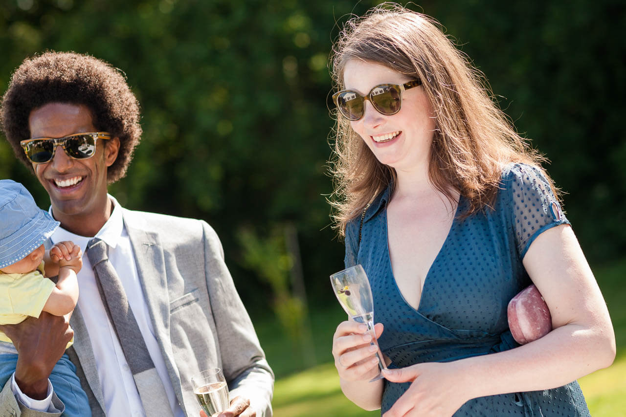 guest holding champagne smiling