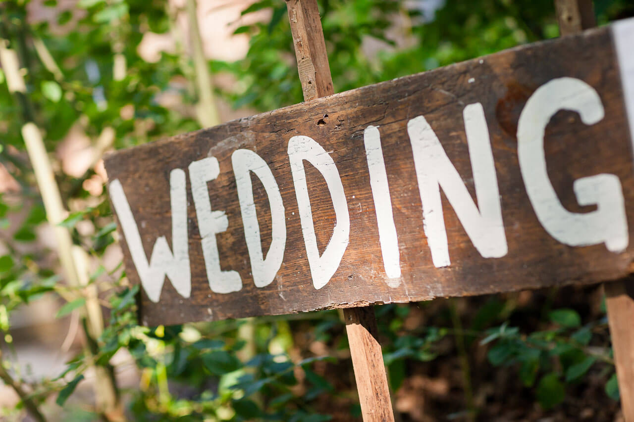 wooden sign post saying 'wedding'