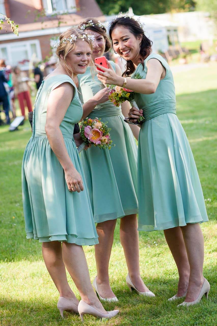 bridesmaids on FaceTime video call all looking into phone