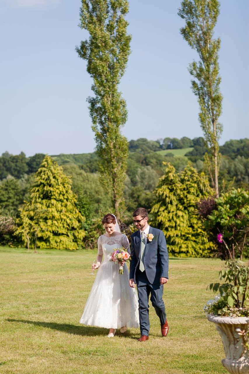 bride and groom taking a stroll around the gardens