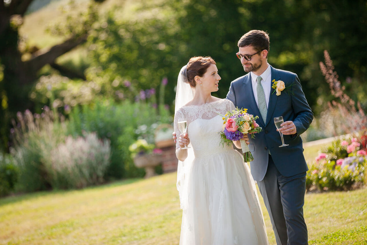 bride and groom walking towards camera looking at each other