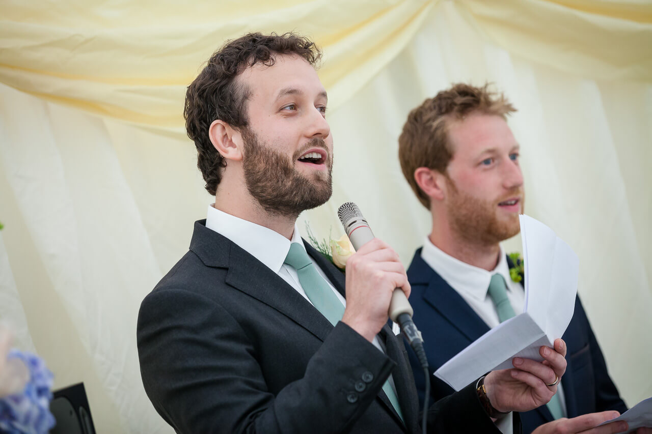 best man holding microphone doing speech