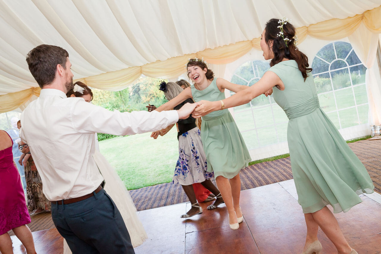 guests dancing to band all holding hands in a circle