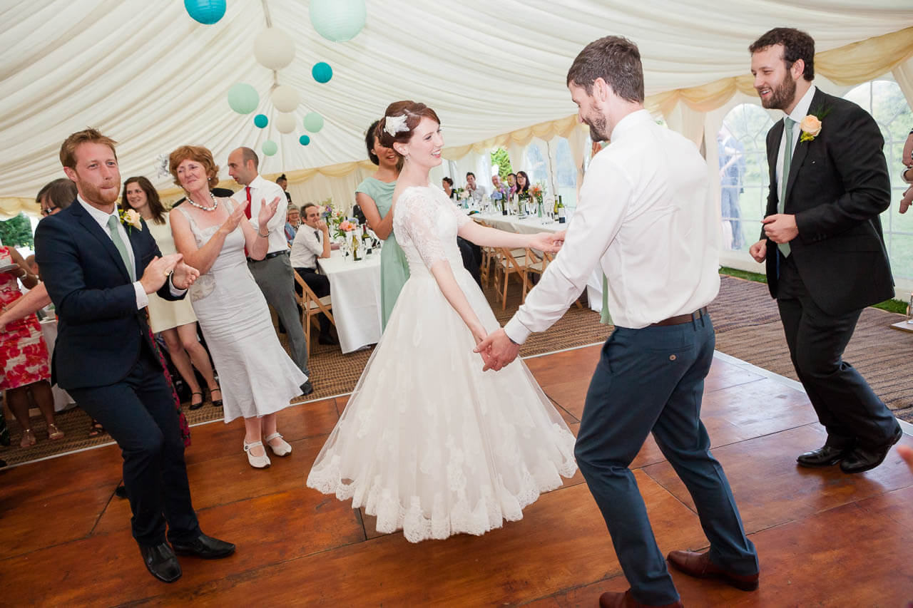 bride and groom holding hands dancing