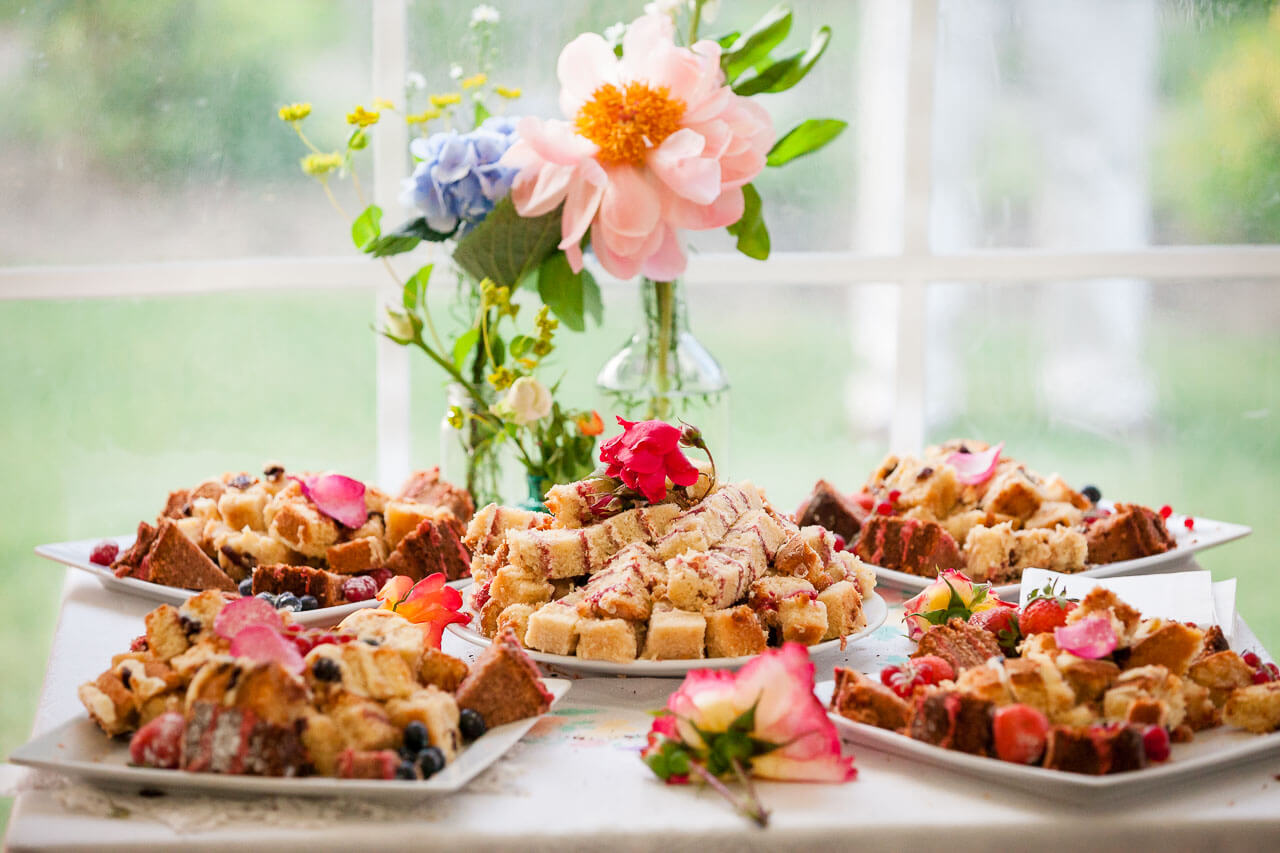 table with plates of cut of wedding cake on