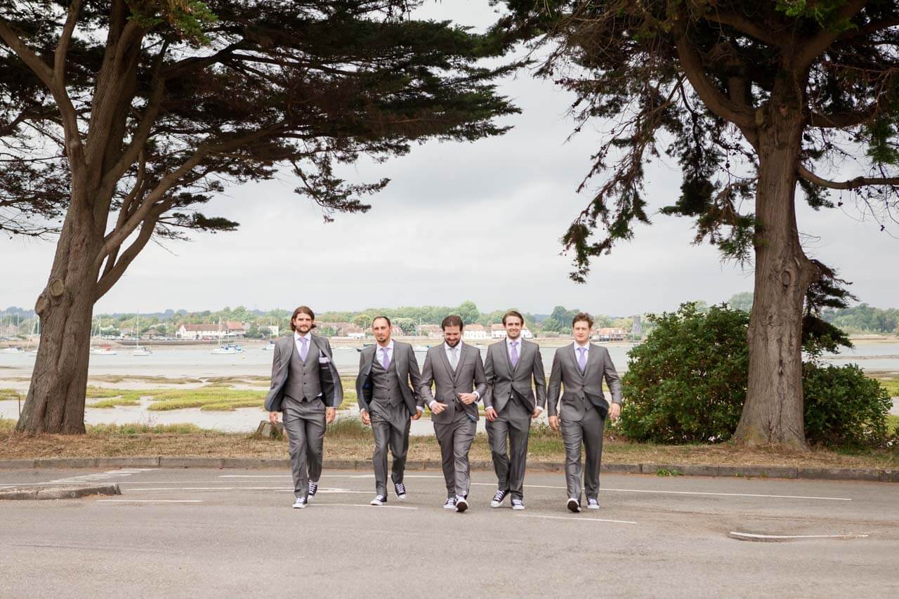 groomsmen all walking towards to the camera in a line