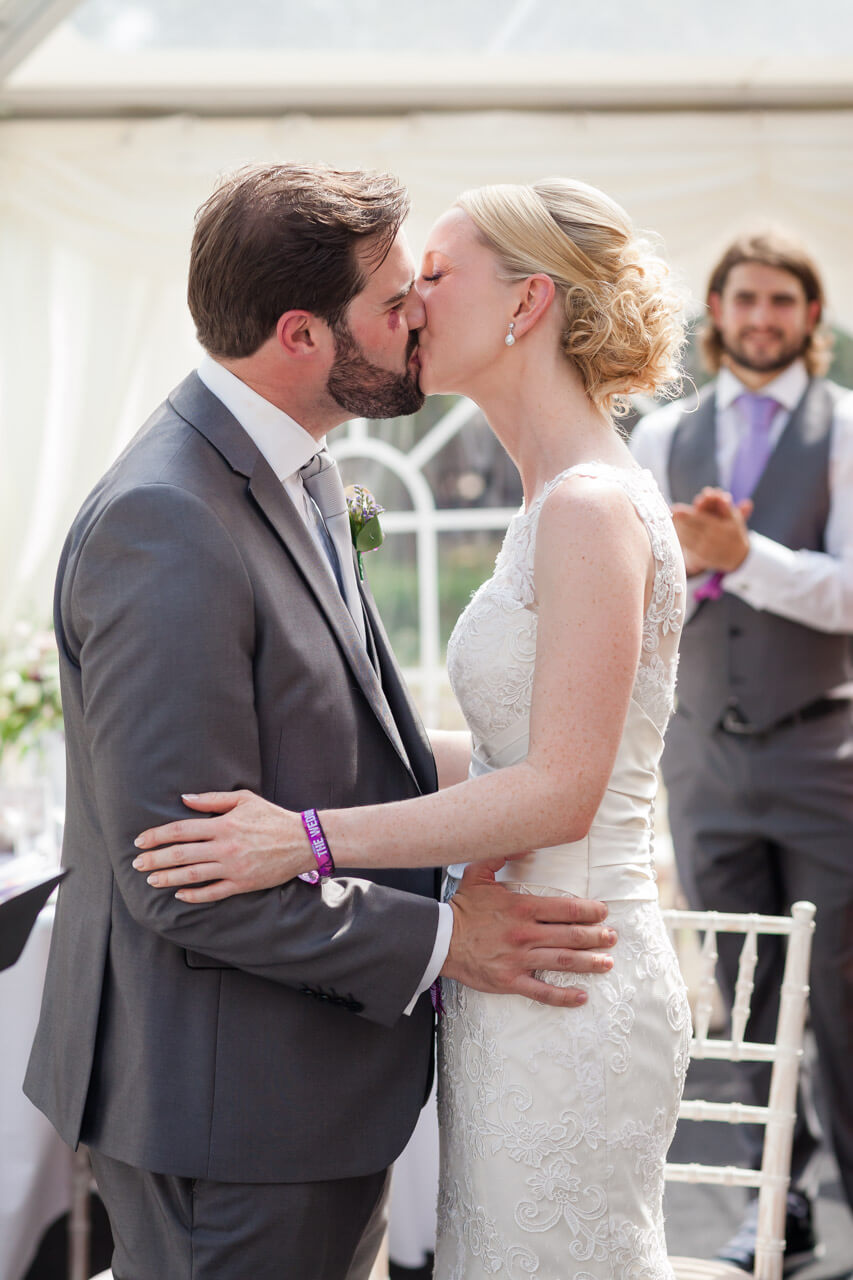 bride and groom first kiss