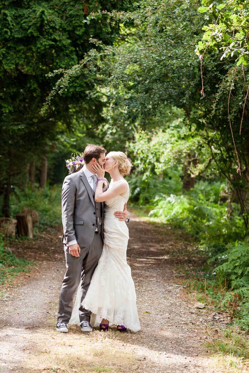 bride and groom portrait shot in woody tree lined lane
