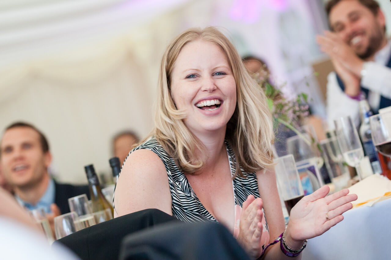 guest laughing while listening to speeches