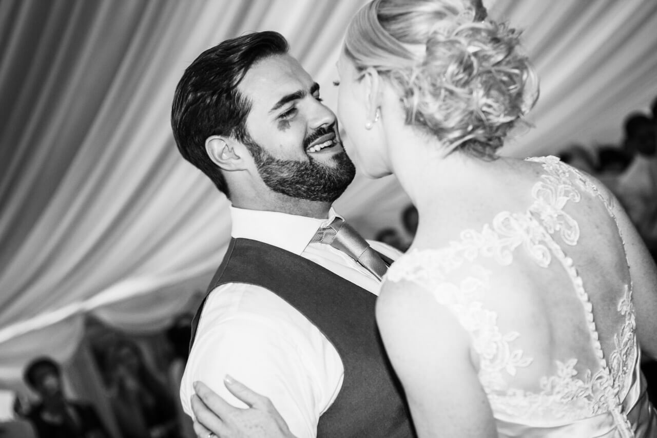 bride and groom first dance groom smiling at bride