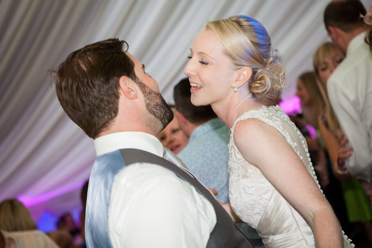 bride and groom singing and dancing doing first dance