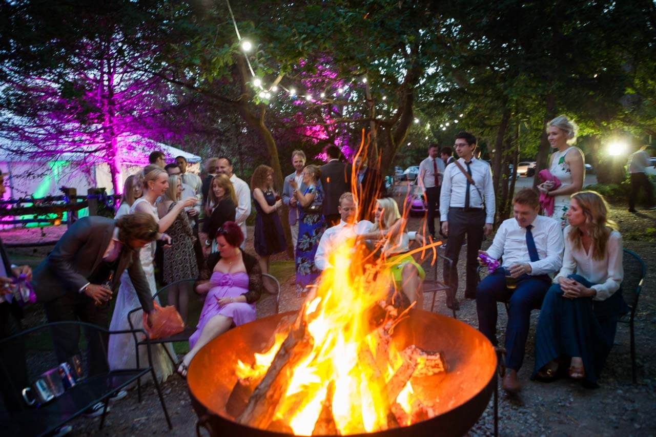 fire pit glowing with guests in background