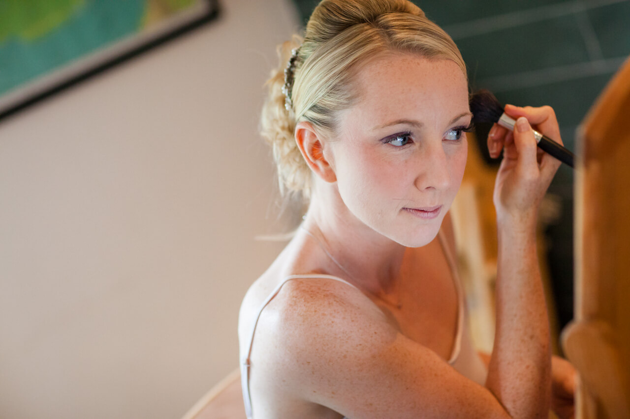 bride getting ready putting on earrings