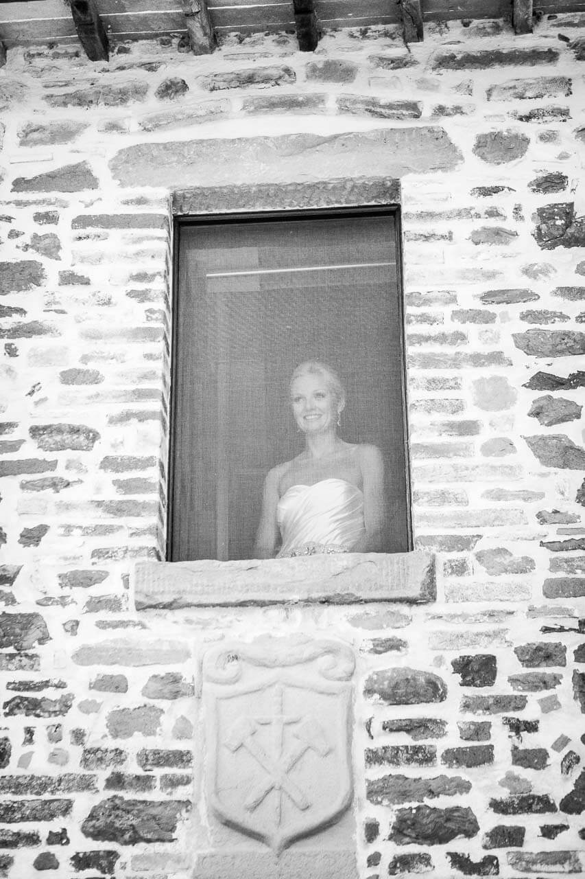 bride looking wistfully out of the window in villa