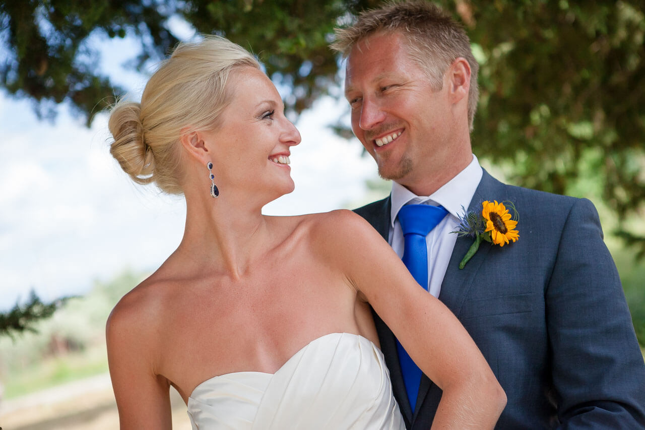 close up portrait of bride and groom looking at each other