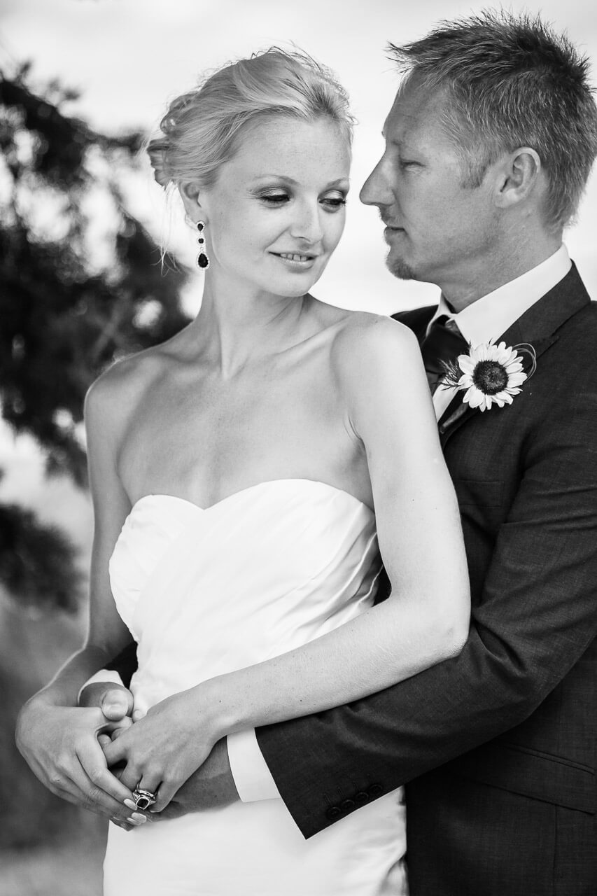 black and white photo of groom into bride's eyes and bride looking down