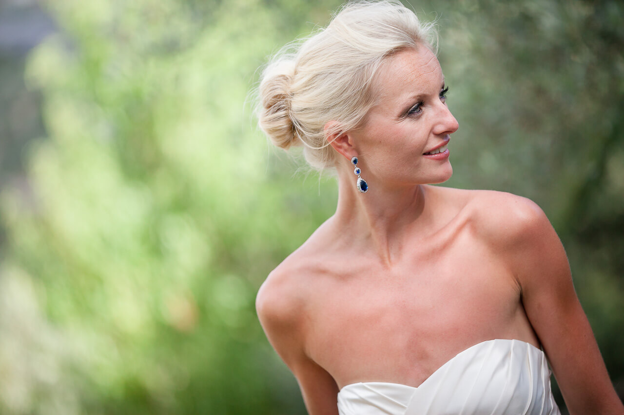 bridal portrait looking away from camera green background