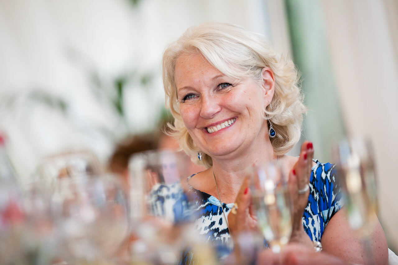 mother of bride looking teary eyed while listening to speeches
