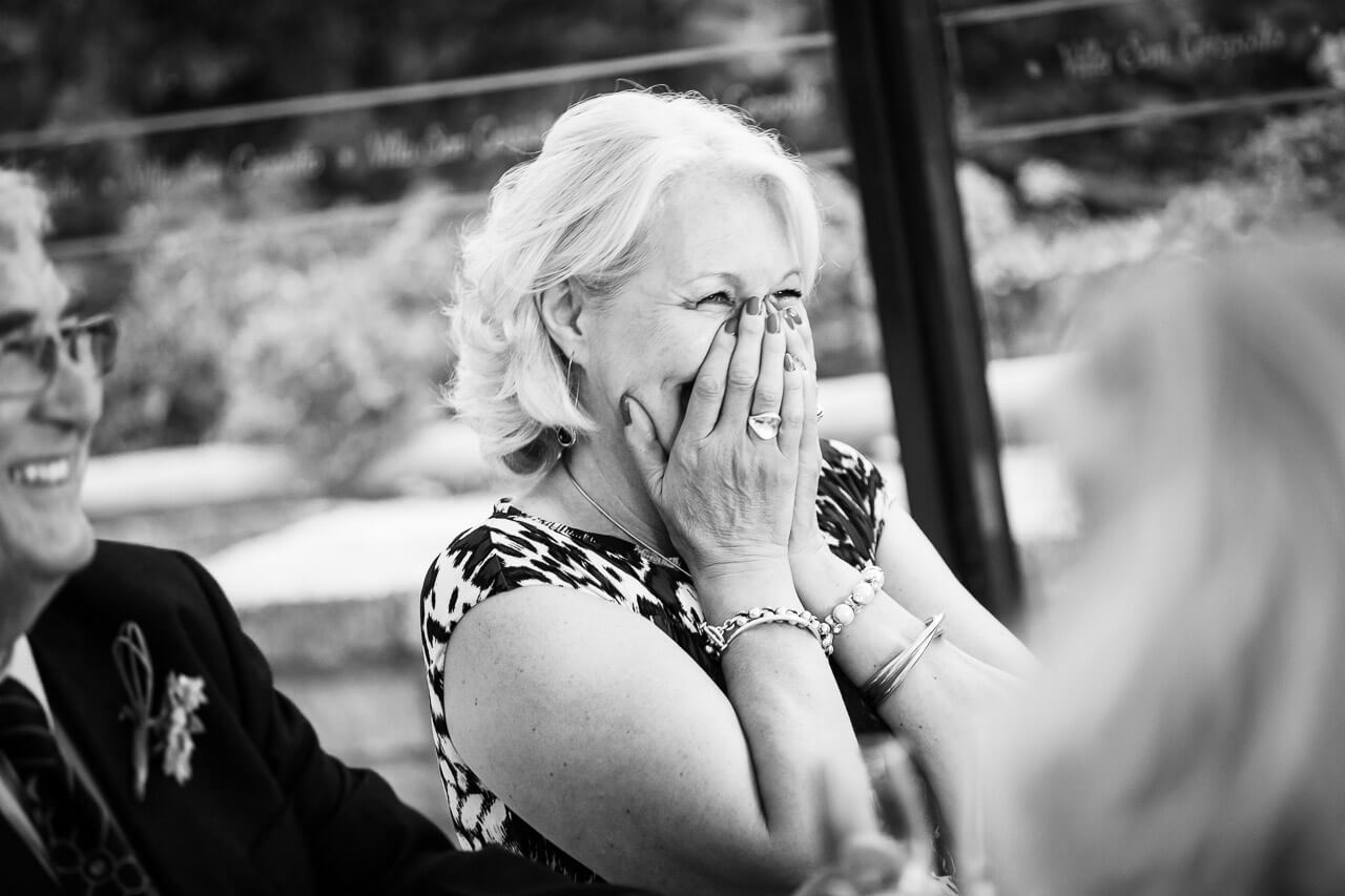 mother of bride hold hands on face due to speech joke