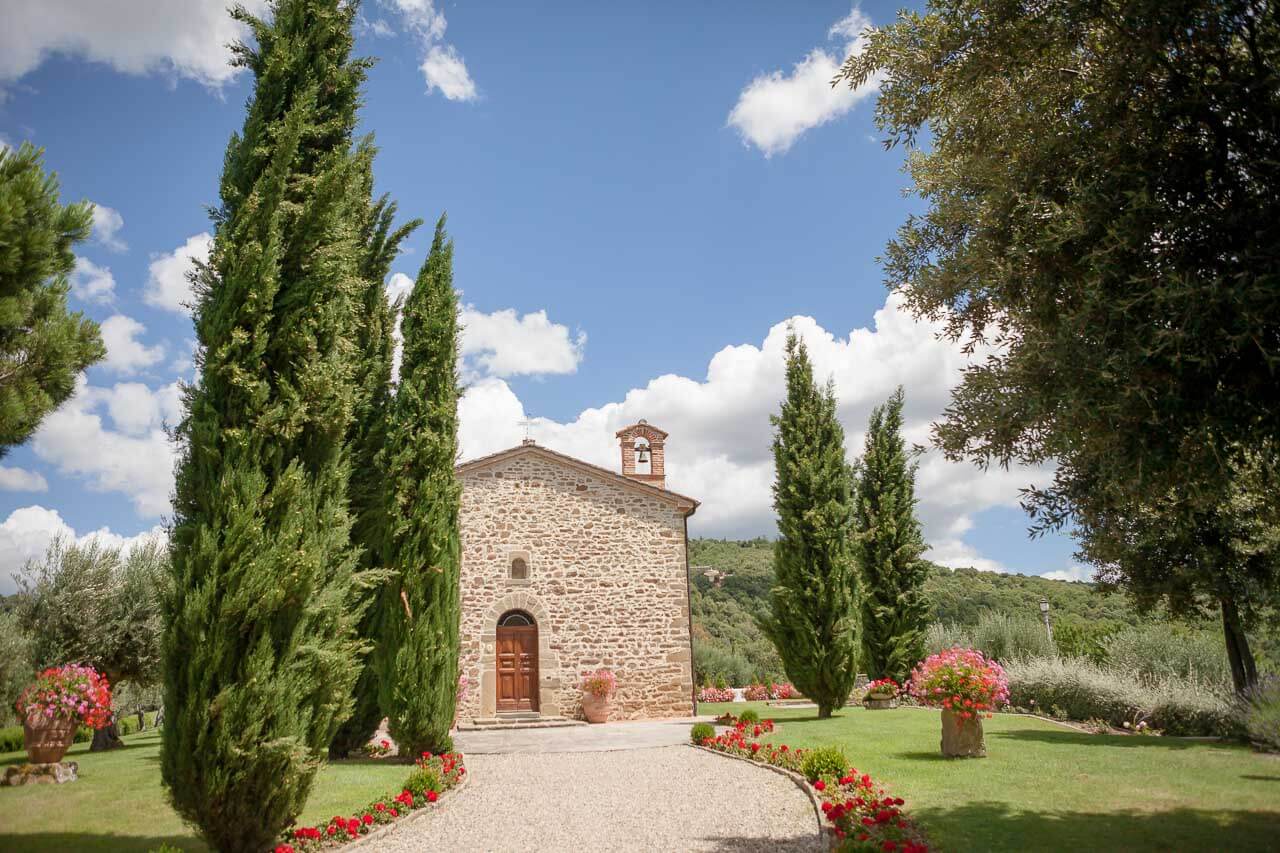 tall trees and driveway of Italian villa