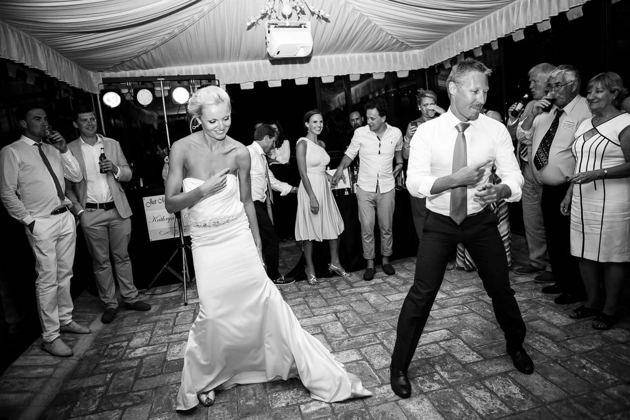 bride and groom breaking out into dance