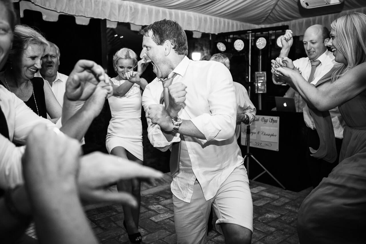 best man dancing in a circle while people look on