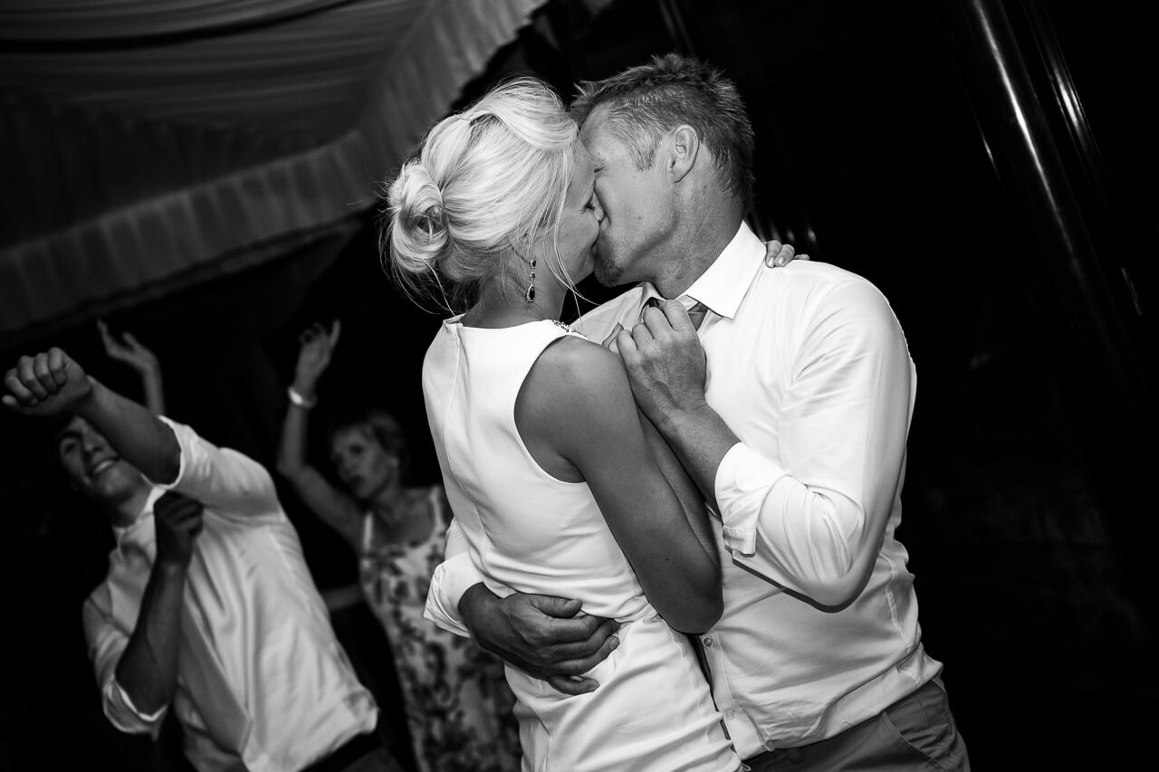 bride and groom kiss on dance floor