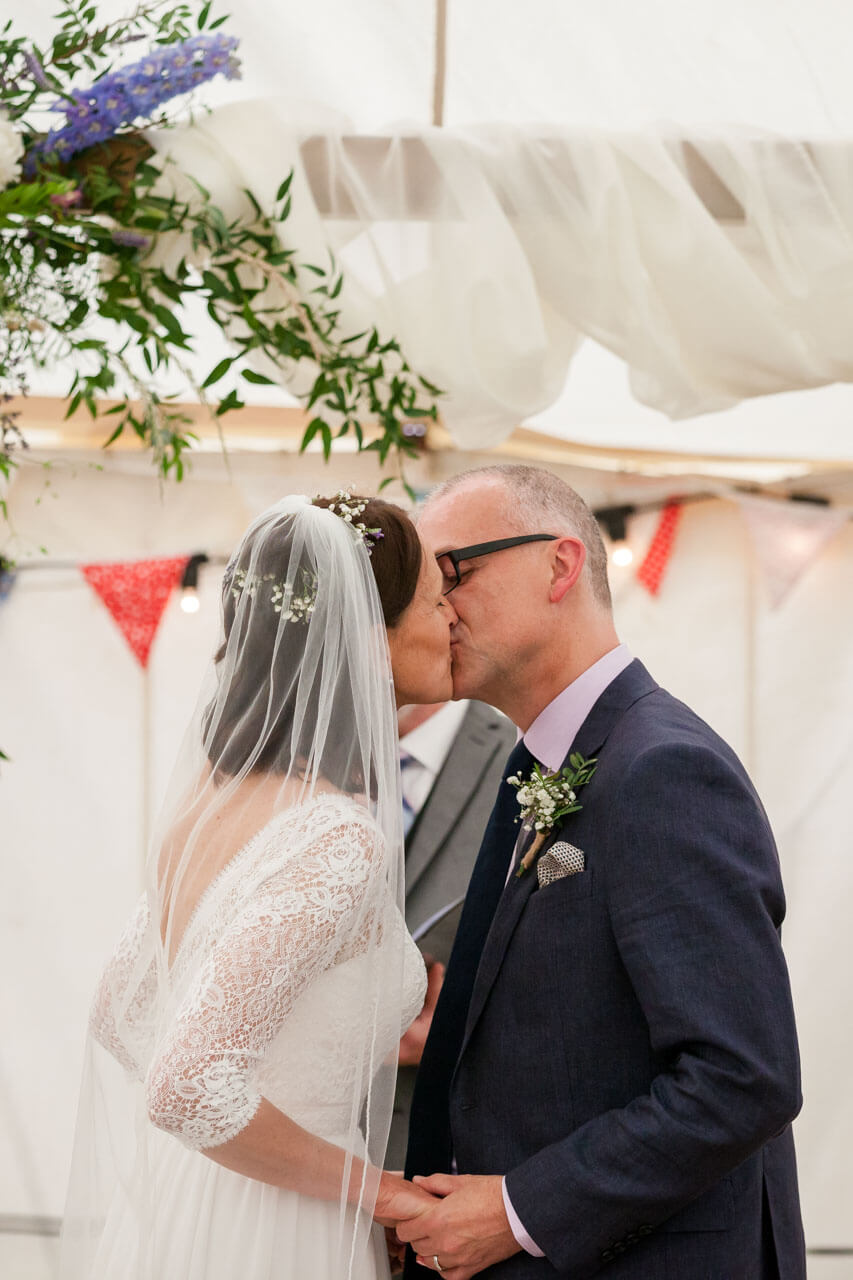 bride kissing groom for the first time