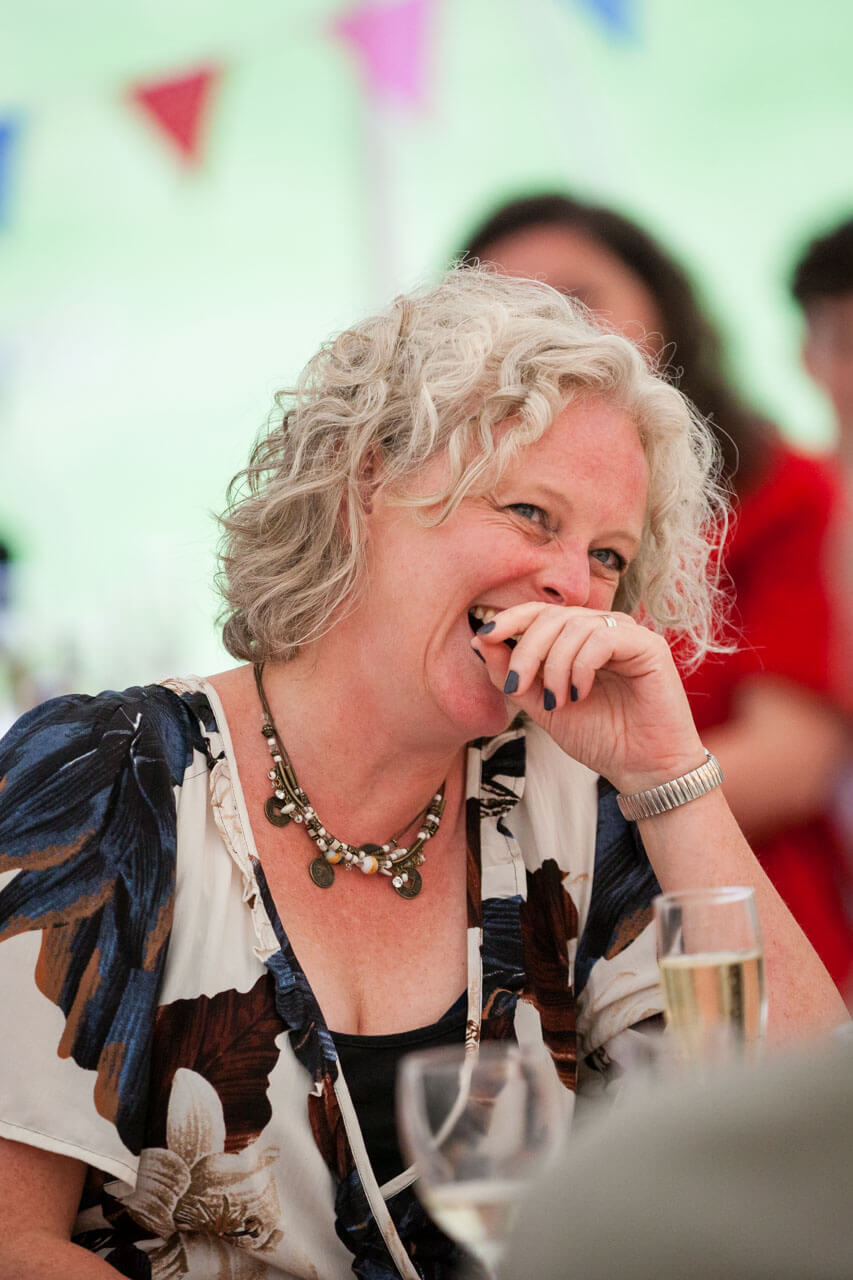 guest hand over mouth laughing at speeches