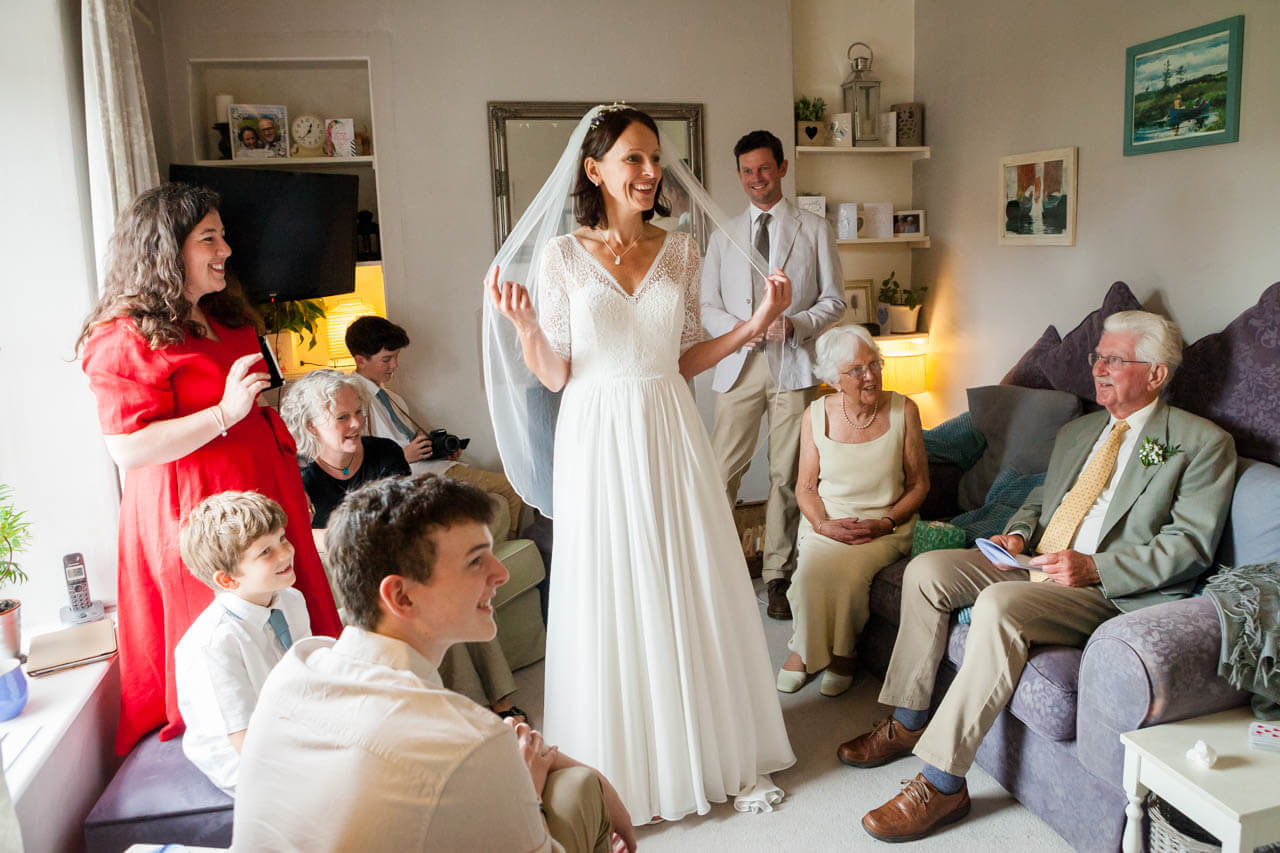 bride showing her dress to her family