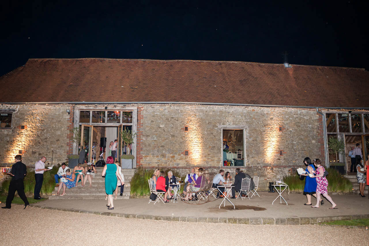 guests hanging out at night besides the barn