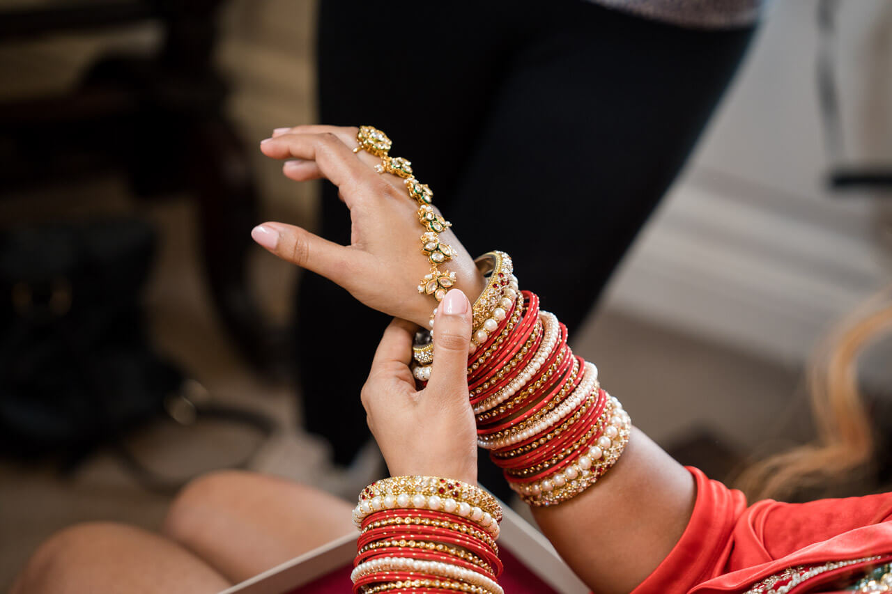 close up of wrist wearing a lot of jewellery