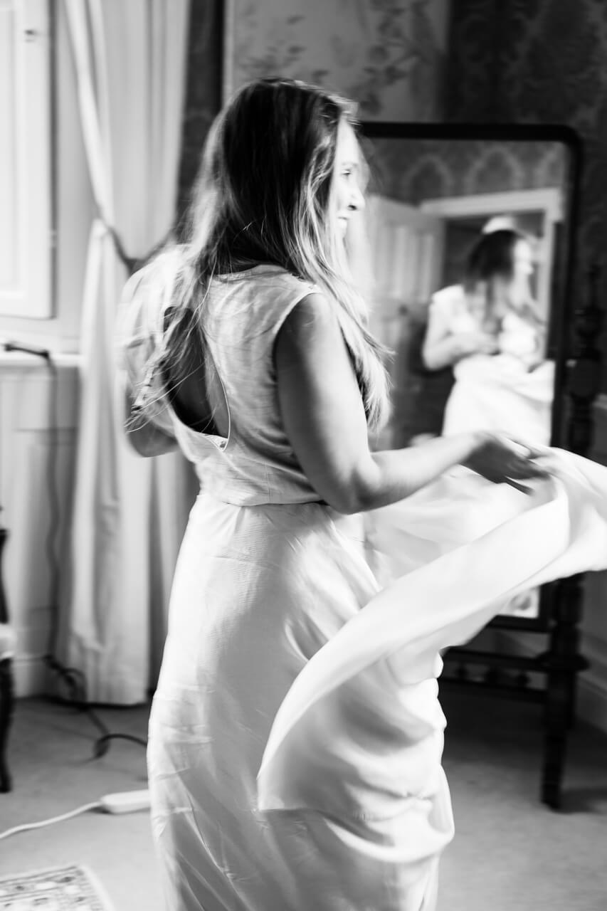 bride in her dress in the morning playing with her train