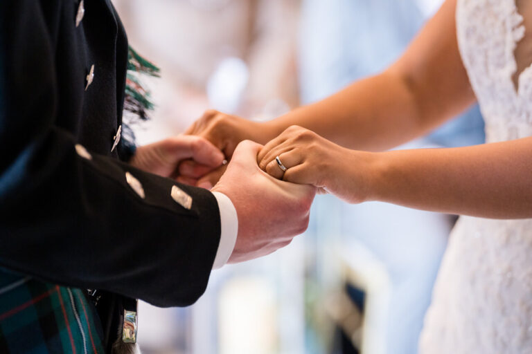 man and wife holding hands during vows