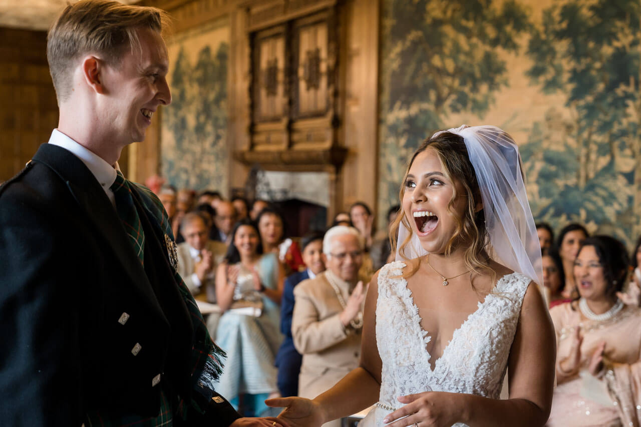 bride laughing with groom during ceremony
