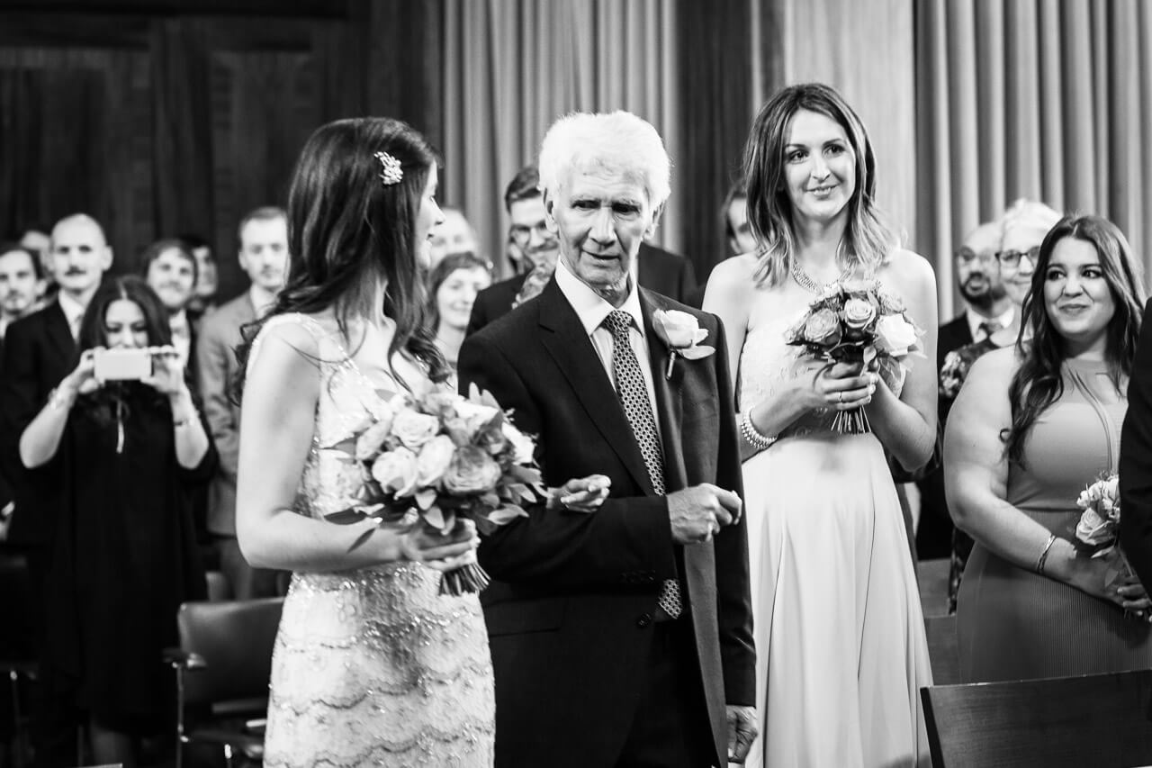 father looking at the bride