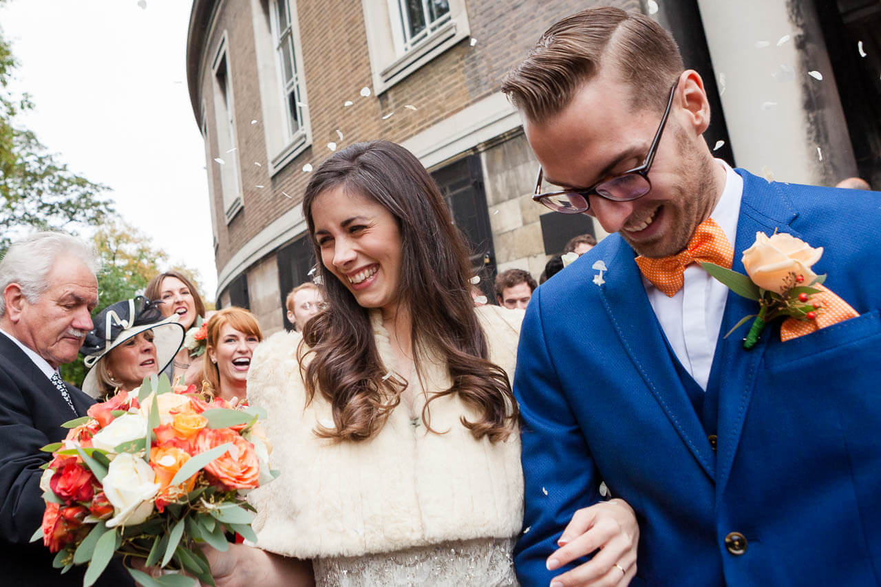 bride laughing holding groom's arm
