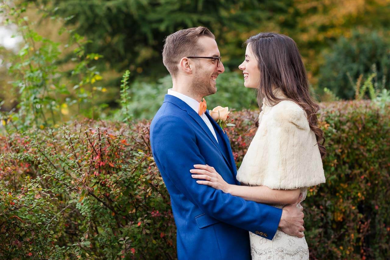 bride and groom holding each other looking at each other