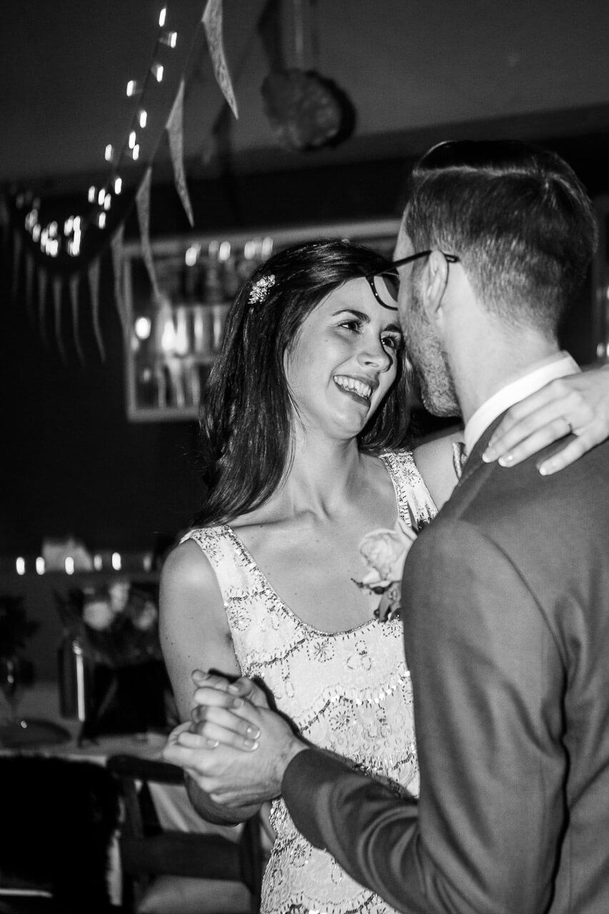 bride smiling at groom during first dance