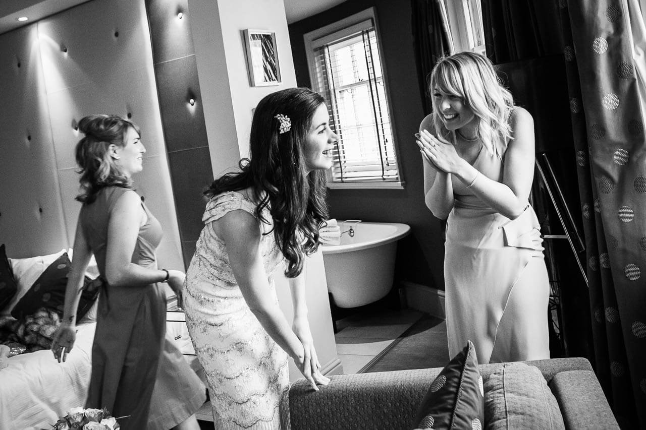 bride and bridesmaids looking out of window