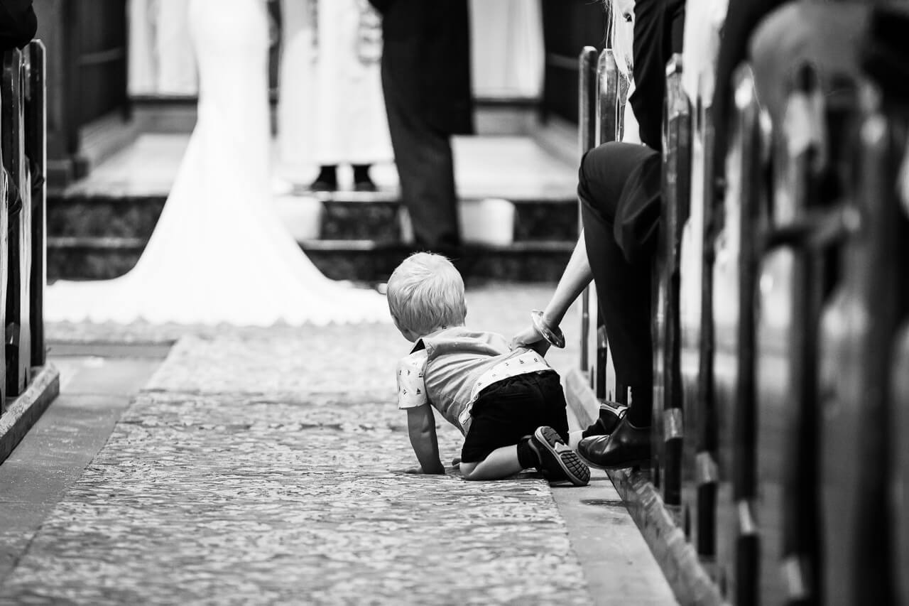 child trying to escape down church aisle
