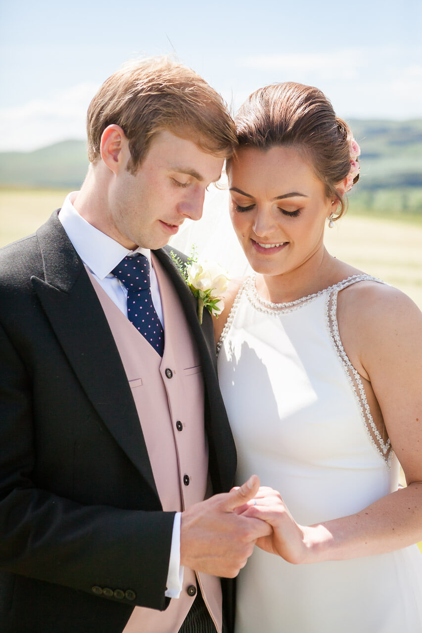 close up couple portrait looking at rings