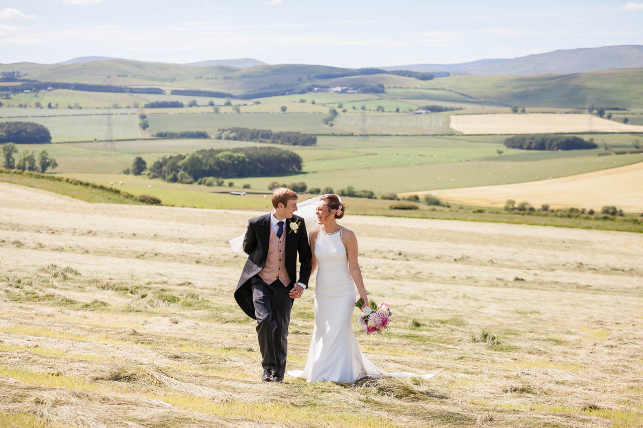 bride and groom walking laughing towards camera