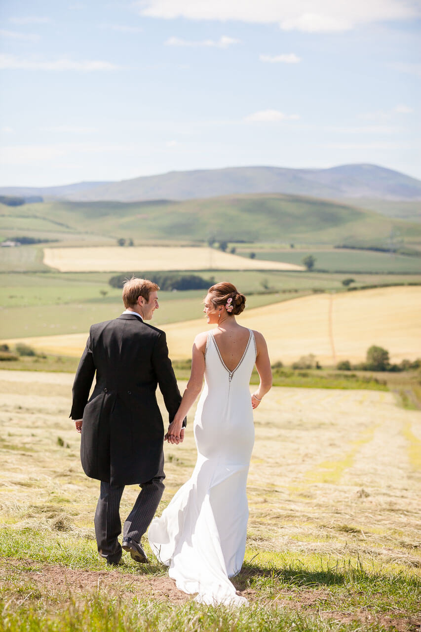 bride and groom walking away from camera