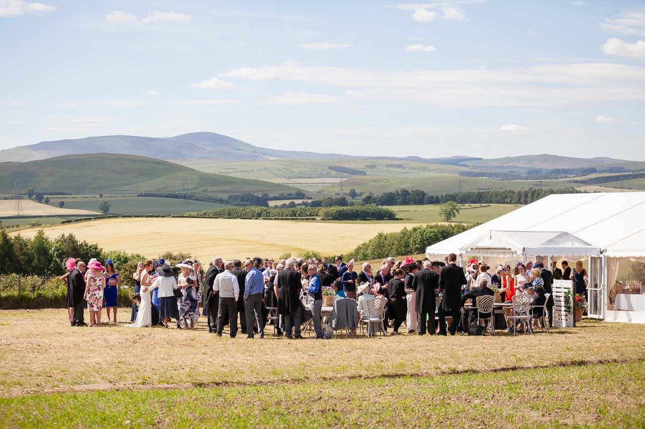 guests mingling by marquee